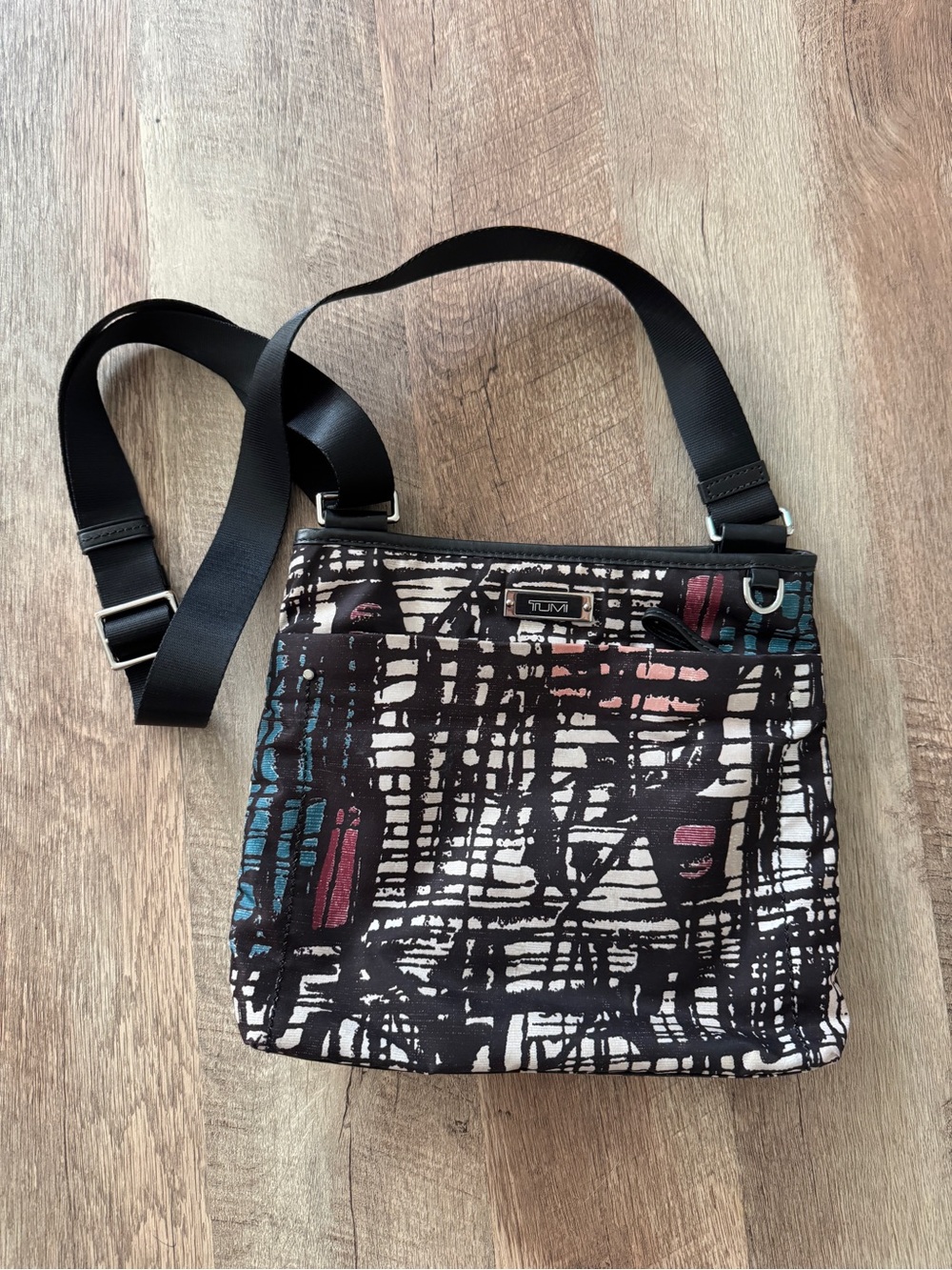 Tumi Black Crossbody Bag with Teal and Mauve Accents